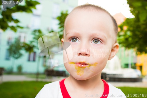 Image of young boy with colorful lollipop