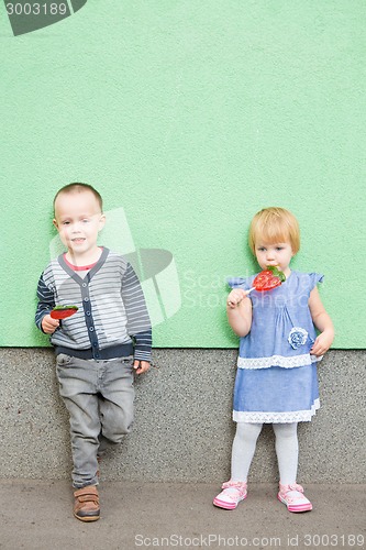 Image of Adorable little kids with colorful lollipops