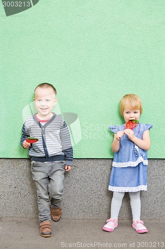 Image of Adorable little kids with colorful lollipops