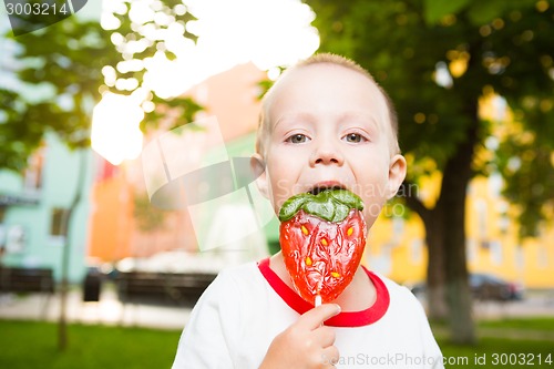 Image of young boy with colorful lollipop