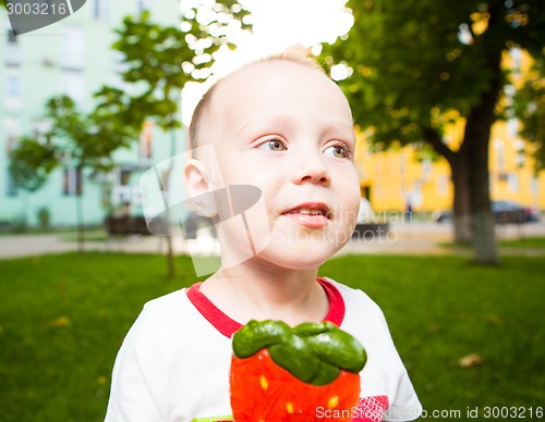 Image of young boy with colorful lollipop