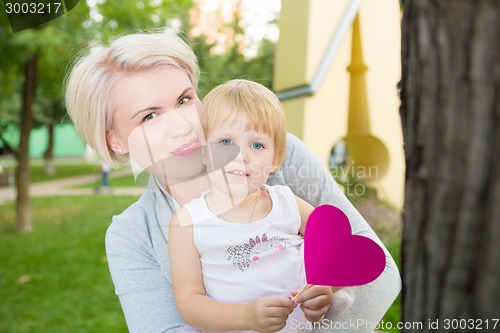 Image of portrait of beautiful mother and kid girl outdoors in park
