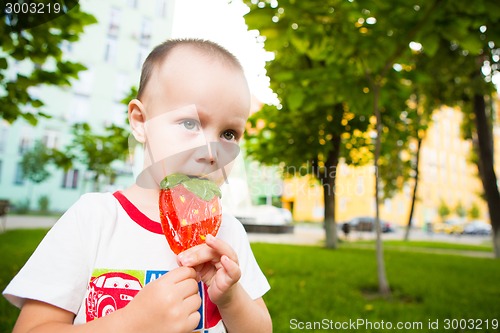 Image of young boy with colorful lollipop