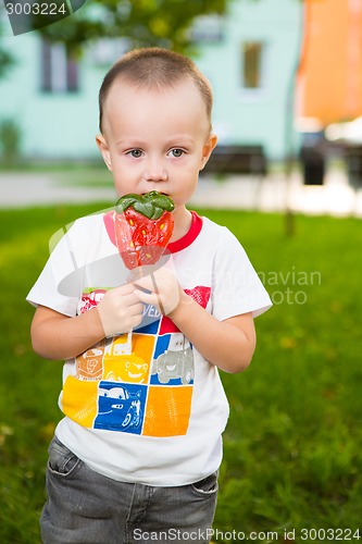 Image of young boy with colorful lollipop