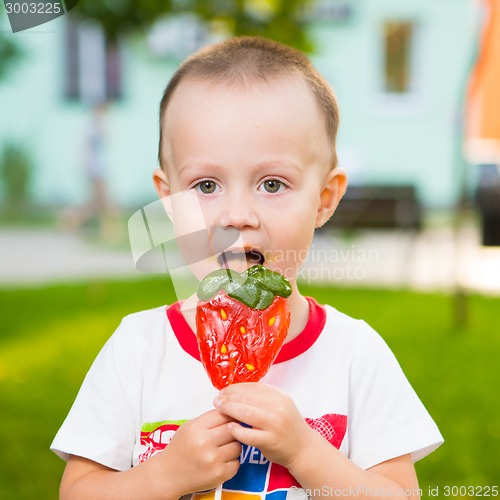 Image of young boy with colorful lollipop