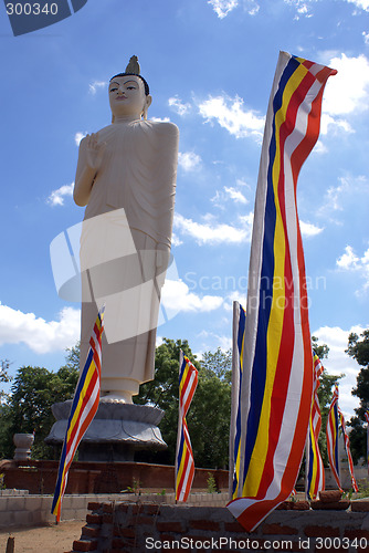 Image of White Buddha and buddhist flags