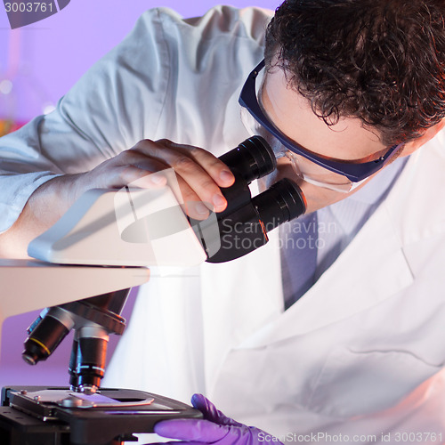 Image of Health care professional microscoping.