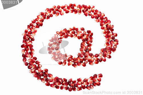 Image of At symbol made from pomegranate seeds