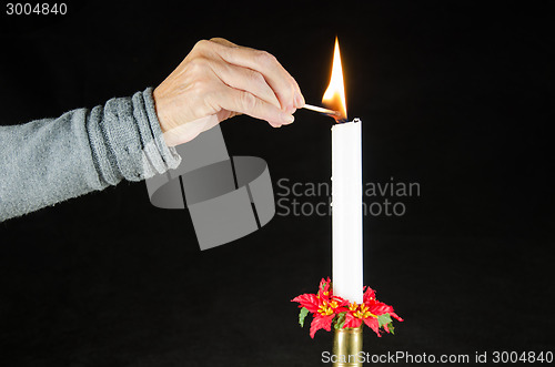Image of Lighting a christmas candle