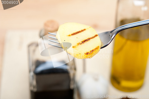 Image of grilled potato on a fork