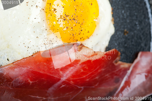 Image of egg sunny side up with italian speck ham