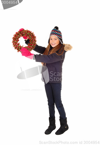 Image of Girl holding a wreath up.