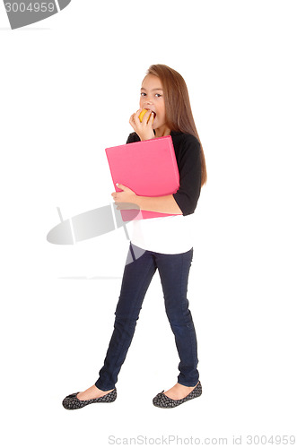 Image of Blond girl eating apple.