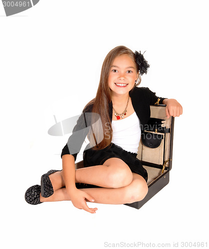 Image of Girl sitting in briefcase.