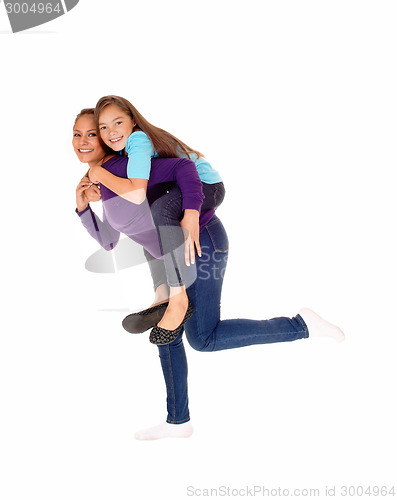 Image of Mother piggyback her daughter.