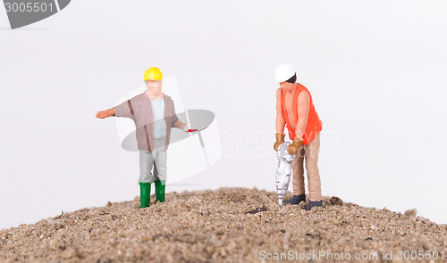 Image of Miniature worker with a power drill