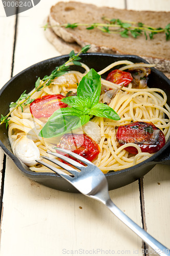 Image of spaghetti pasta with baked cherry tomatoes and basil 