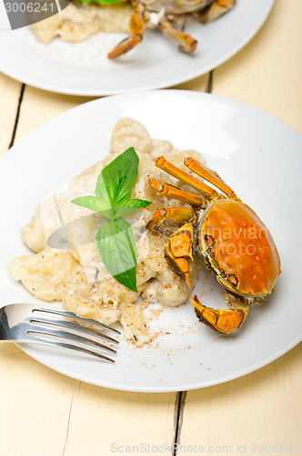 Image of Italian gnocchi with seafood sauce with crab and basil