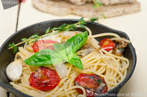 Image of spaghetti pasta with baked cherry tomatoes and basil 