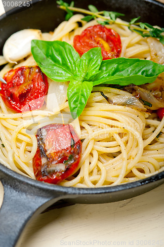 Image of spaghetti pasta with baked cherry tomatoes and basil 