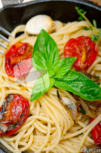 Image of spaghetti pasta with baked cherry tomatoes and basil 