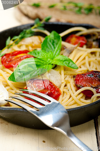 Image of spaghetti pasta with baked cherry tomatoes and basil 