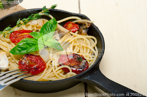 Image of spaghetti pasta with baked cherry tomatoes and basil 