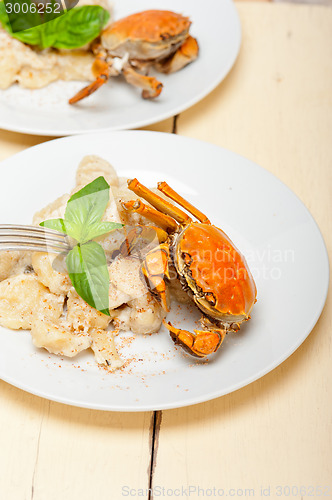 Image of Italian gnocchi with seafood sauce with crab and basil