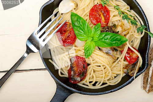 Image of spaghetti pasta with baked cherry tomatoes and basil 