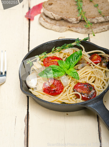 Image of spaghetti pasta with baked cherry tomatoes and basil 