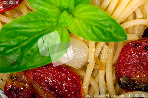 Image of spaghetti pasta with baked cherry tomatoes and basil 