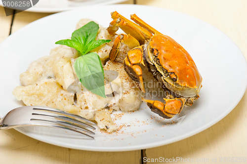 Image of Italian gnocchi with seafood sauce with crab and basil