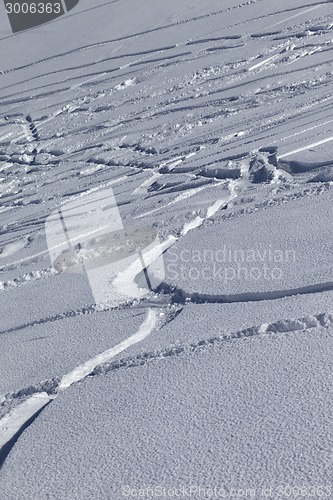 Image of Traces of skis and snowboards in new-fallen snow 
