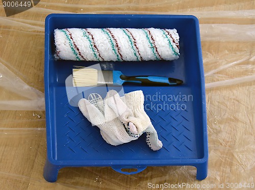 Image of brush, gloves, roller and paint tray 