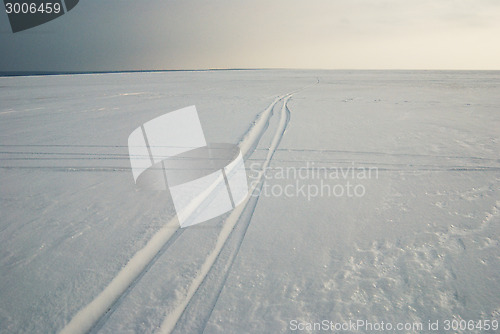 Image of tracks on frozen snowcovered lake