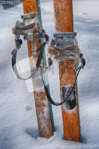 Image of old wooden skis in the snow