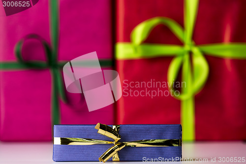 Image of Three bowknots tied around gifts
