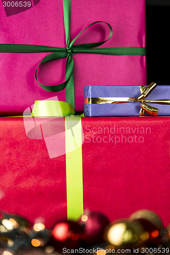 Image of Three wrapped gifts, bowknots, spheres and glitters
