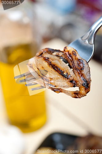 Image of grilled onion on a fork