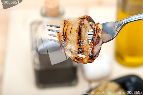 Image of grilled onion on a fork