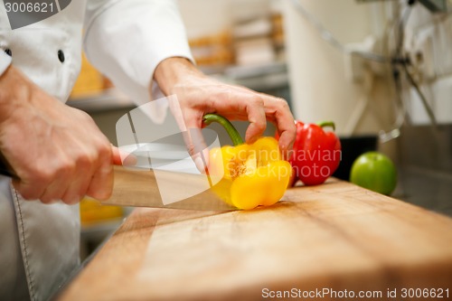 Image of man's hands cutting pepper. Salad preparation