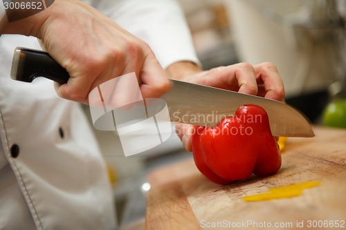 Image of man's hands cutting pepper. Salad preparation