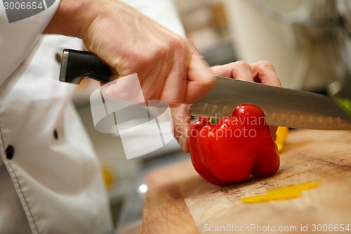 Image of man's hands cutting pepper. Salad preparation