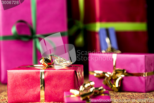 Image of Red Gift Parcel amidst other Presents