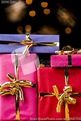 Image of Four Single-Colored Gifts with Golden Bows