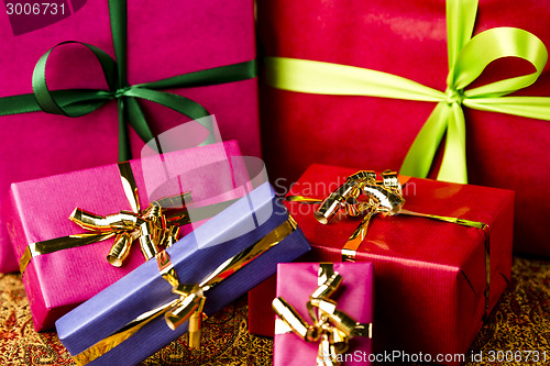 Image of Six Bows Tied around Unicolored Gift Boxes