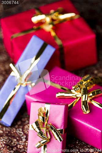 Image of Four Wrapped Gifts with Golden Bows
