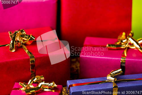 Image of Four Golden Bows around Wrapped Presents