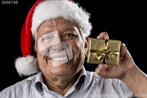 Image of Old Gentleman With Red Hat Offering Golden Gift