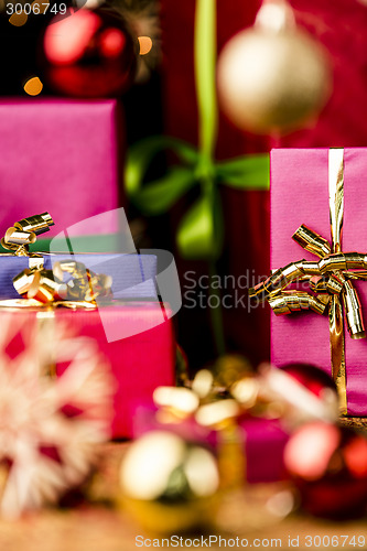 Image of Magenta and Blue Gifts amidst Golden Glitter